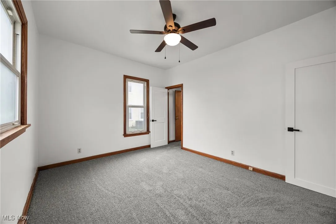 Unfurnished bedroom with carpet flooring and ceiling fan