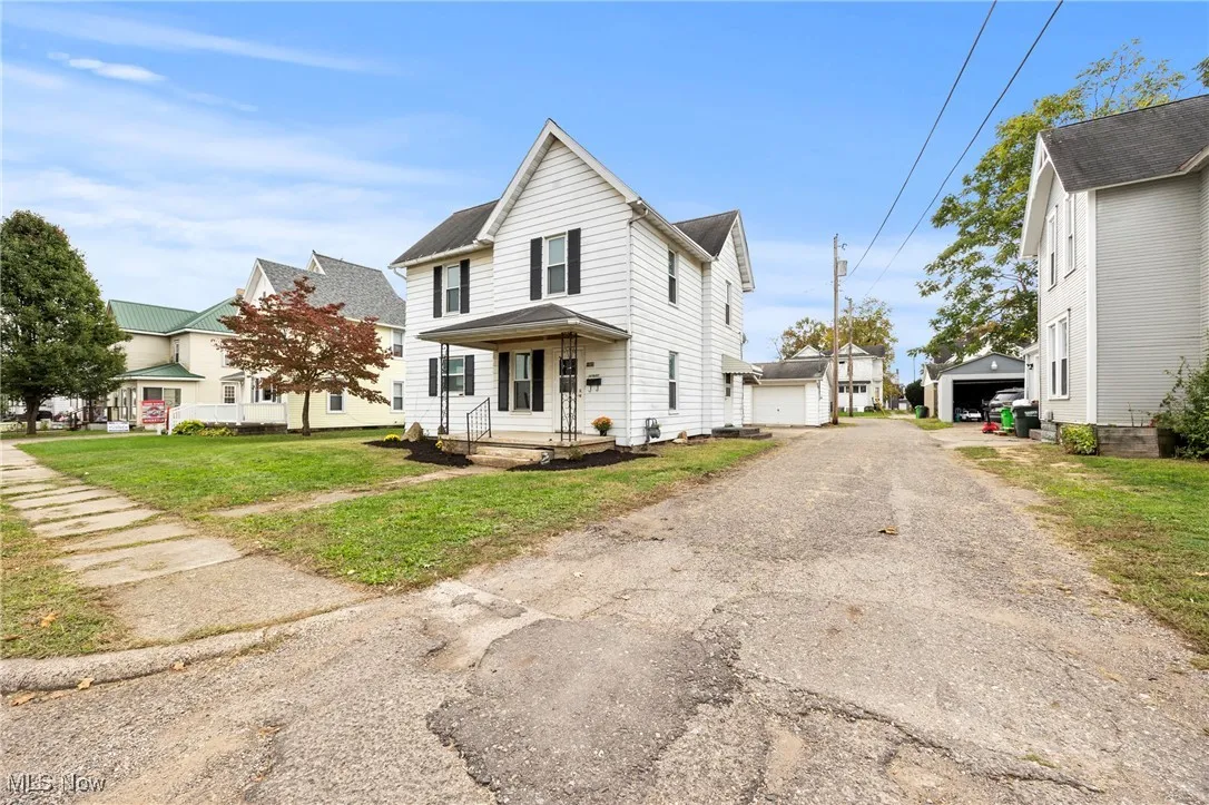 View of front of house featuring a front lawn and a detached garage