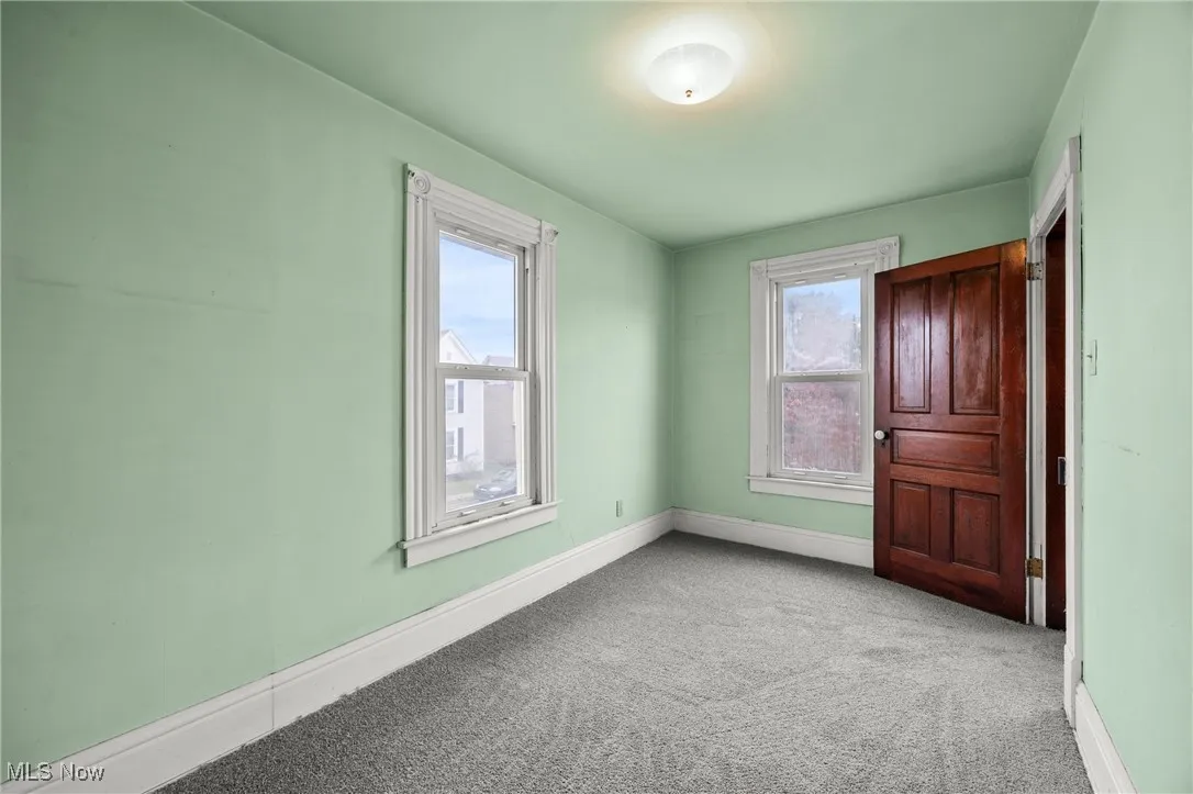 Unfurnished bedroom featuring carpet flooring and baseboards