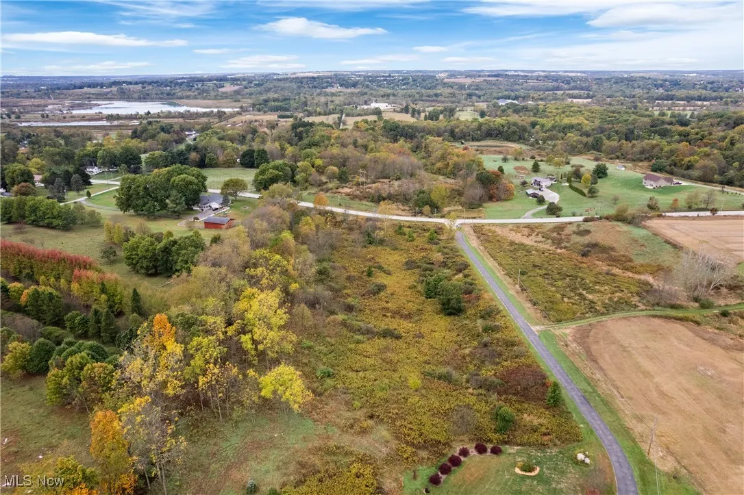 Aerial view of property's location with a large body of water