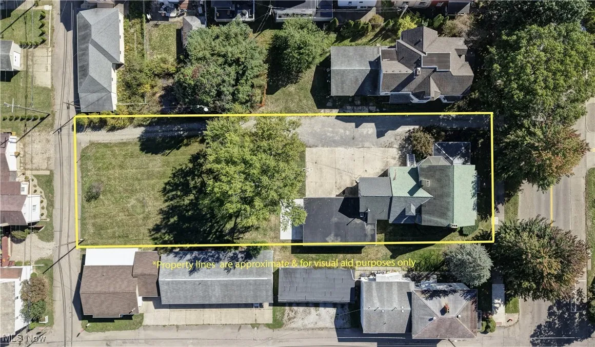 Aerial perspective of suburban area featuring property boundaries highlighted