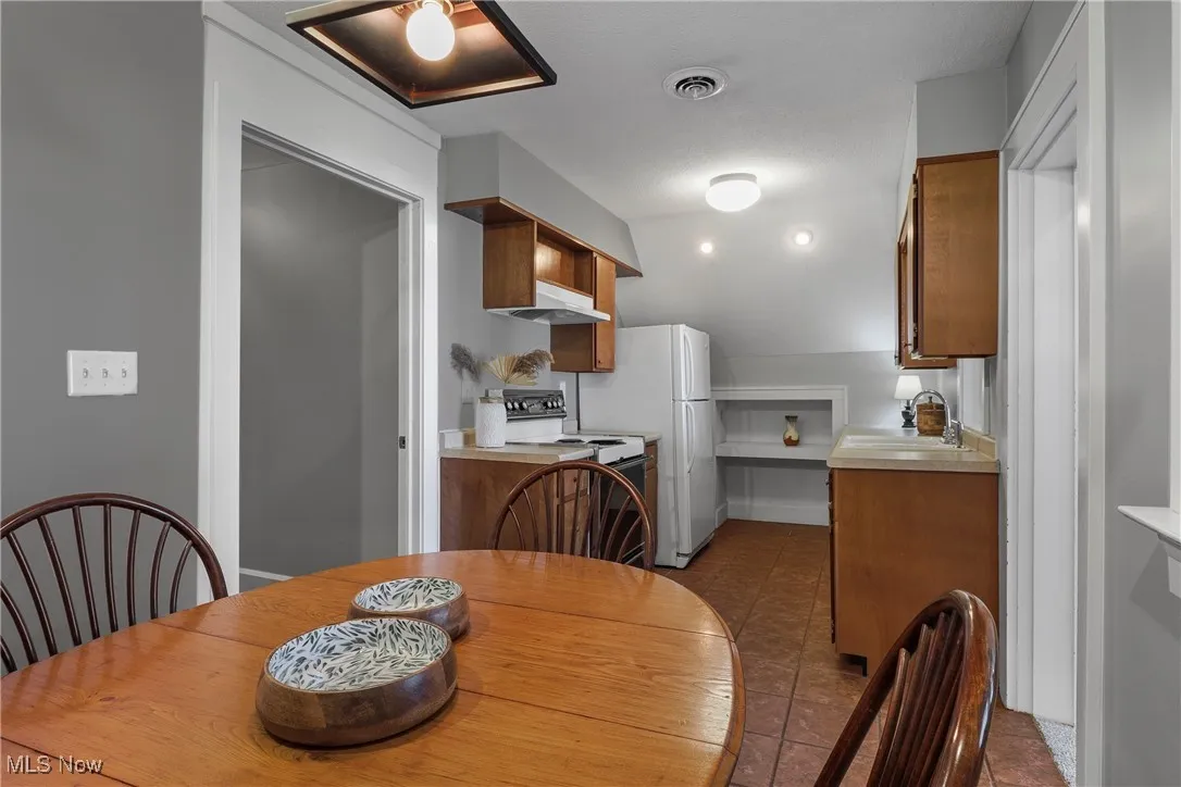 Dining space featuring dark tile patterned floors