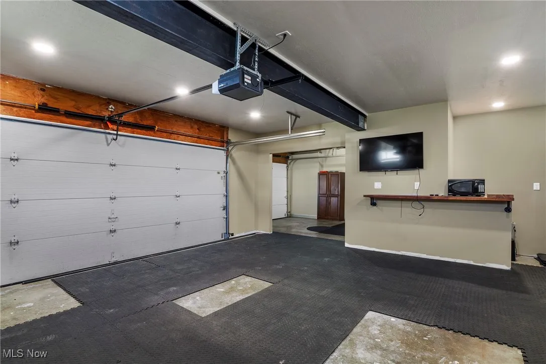 Garage featuring recessed lighting and a garage door opener