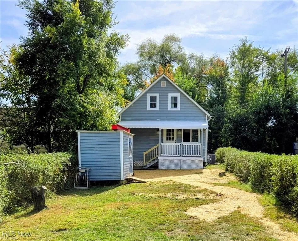 Rear view of house featuring a yard