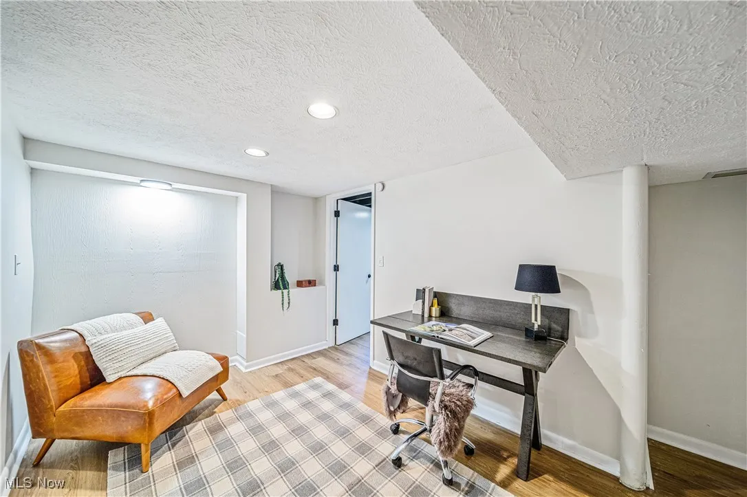 Office featuring a textured ceiling and light hardwood / wood-style flooring