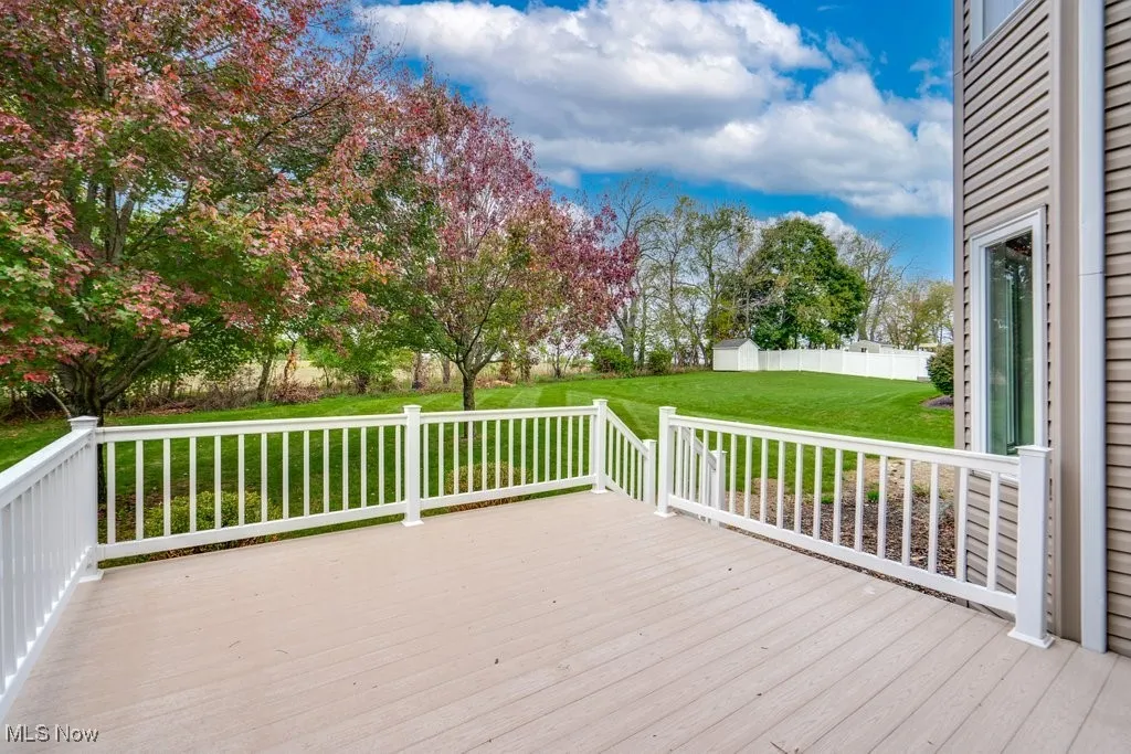 Wooden deck featuring a yard and an outdoor structure