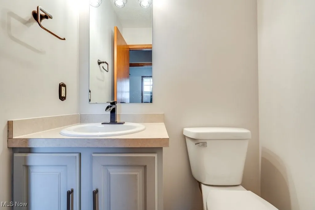 Main level h
alf bath featuring vanity and toilet