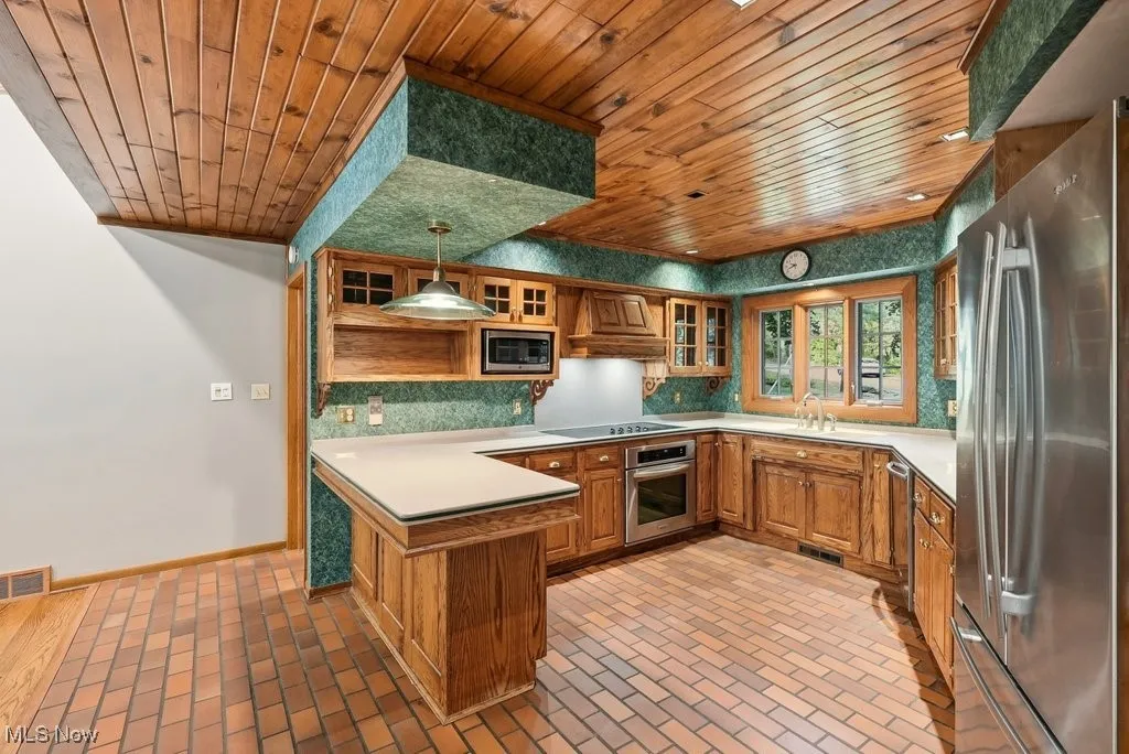 Kitchen with wood cabinetry and breakfast bar
