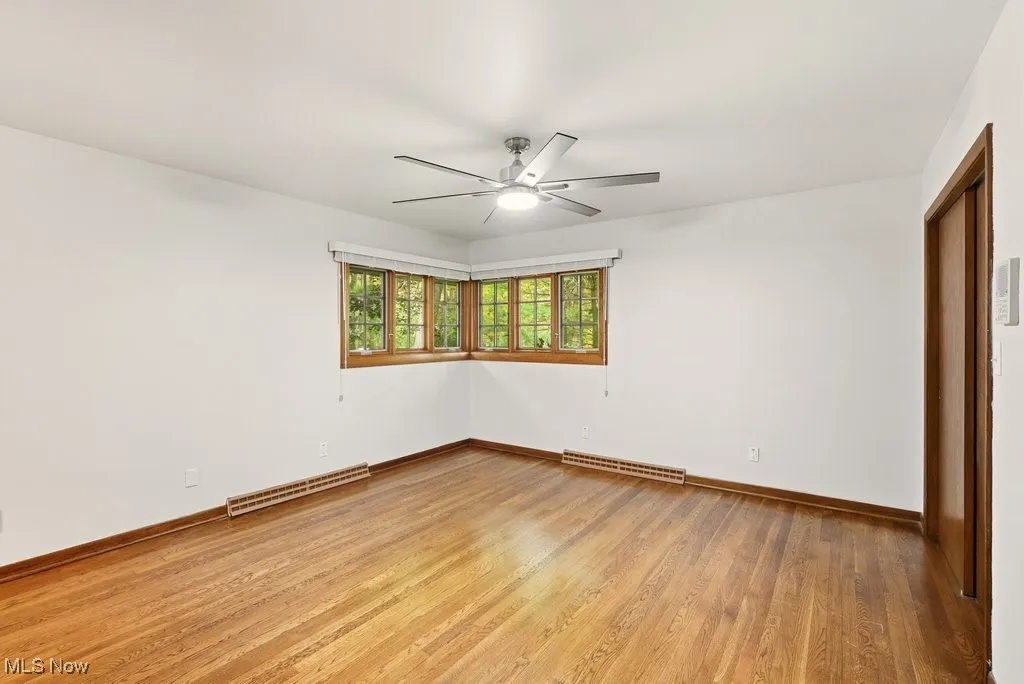Primary bedroom with hardwood flooring