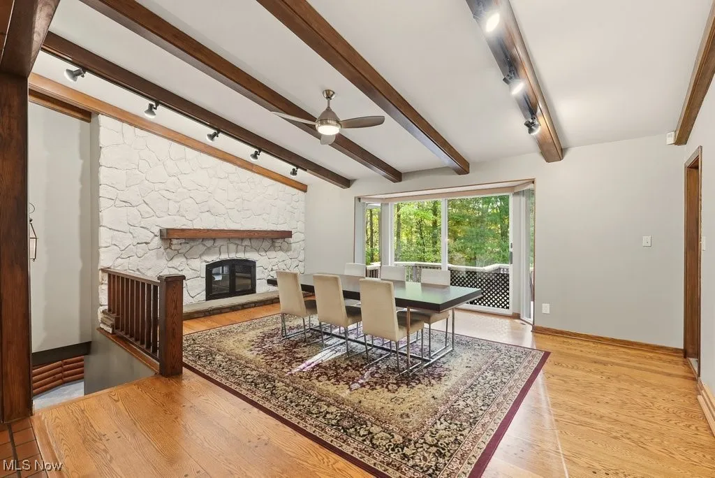Family room or dining room with fireplace and deck access