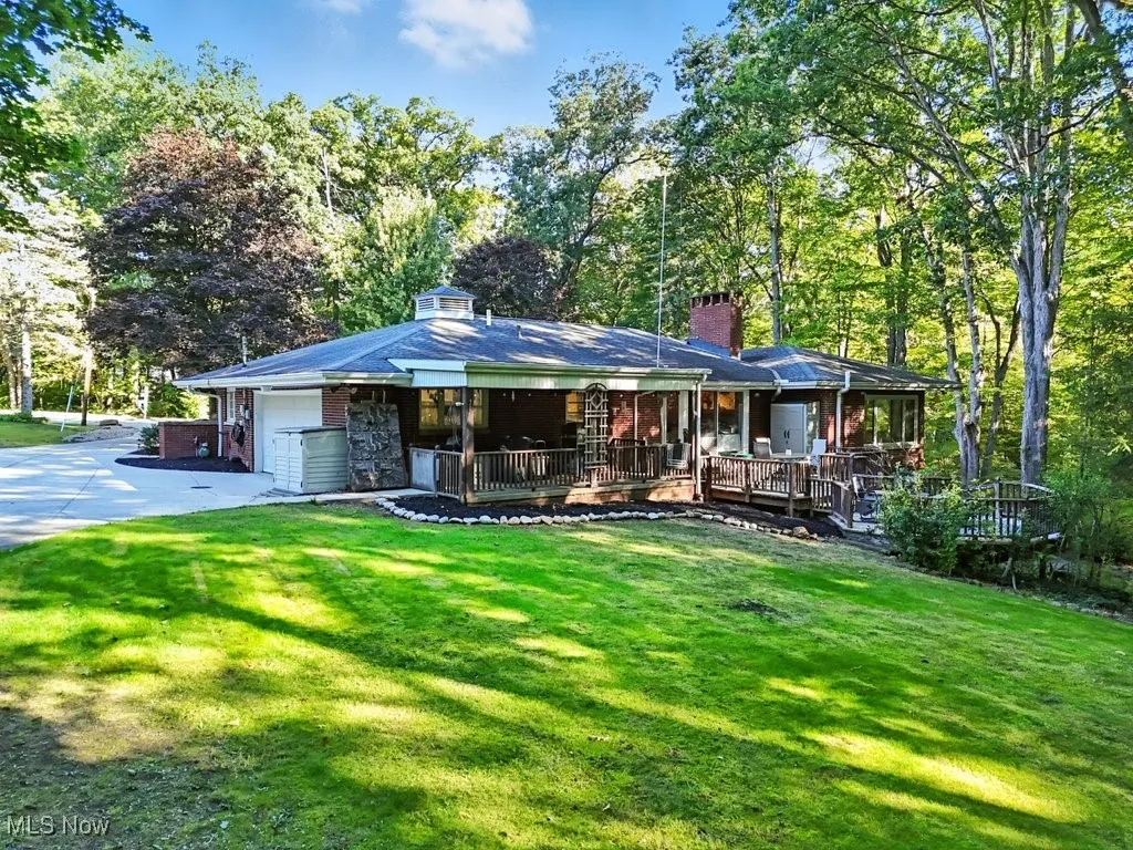 Back view with deck and covered patio