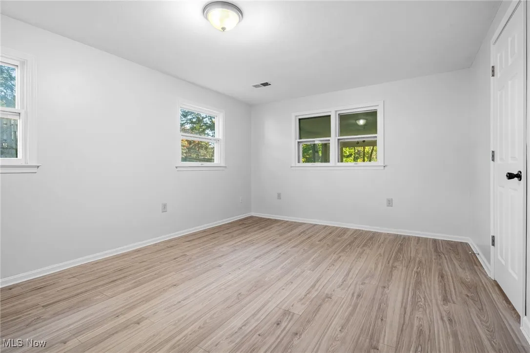 Unfurnished bedroom featuring light wood-style flooring and baseboards