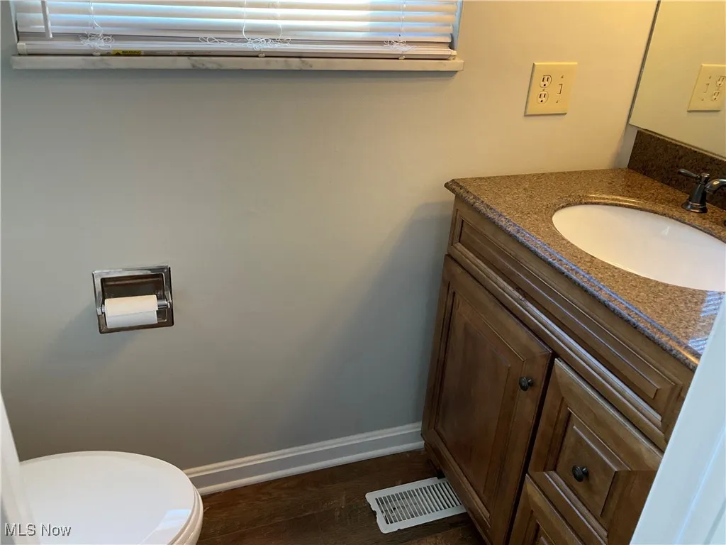 Bathroom featuring vanity and toilet