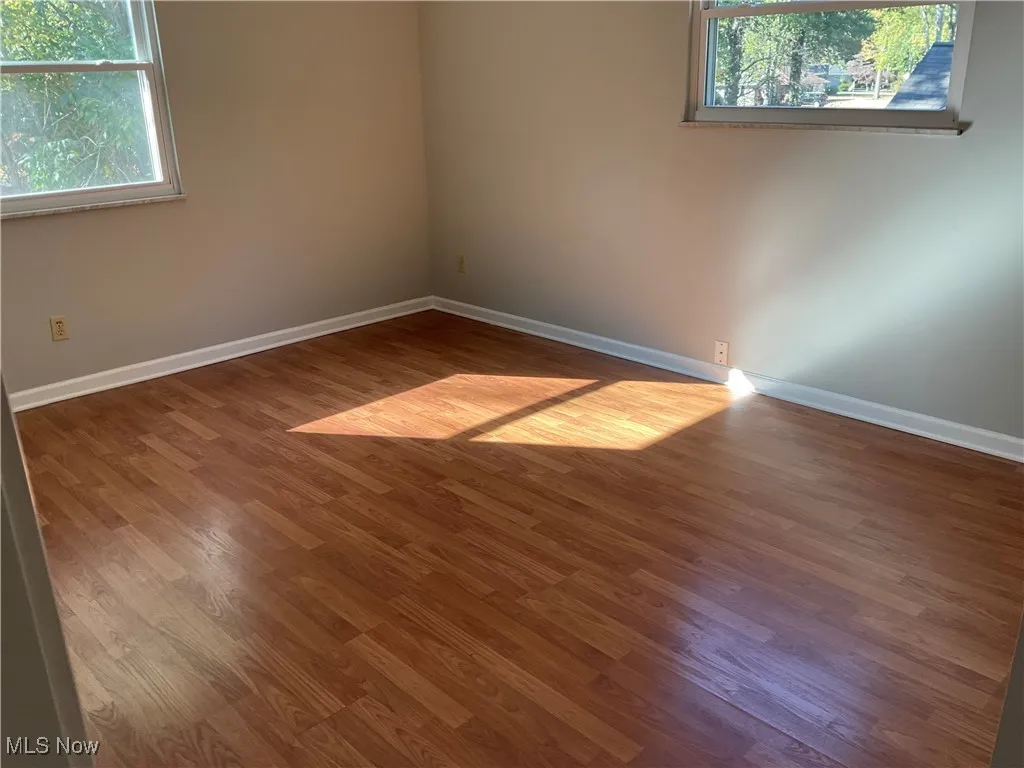 Spare room with light wood-style flooring and baseboards