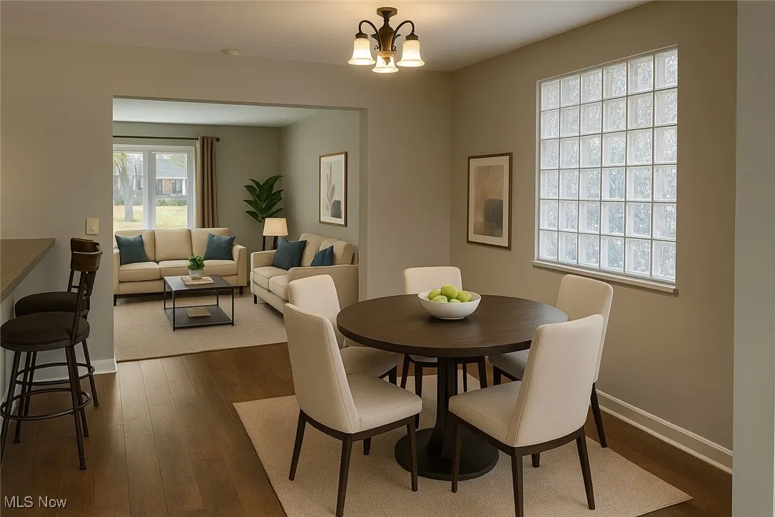 Dining room with dark wood-type flooring and a chandelier
