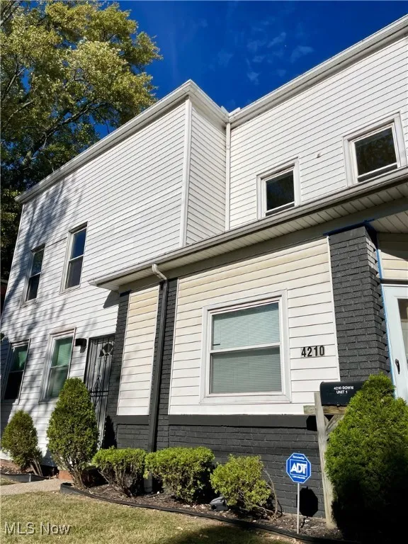 View of side of property featuring brick siding