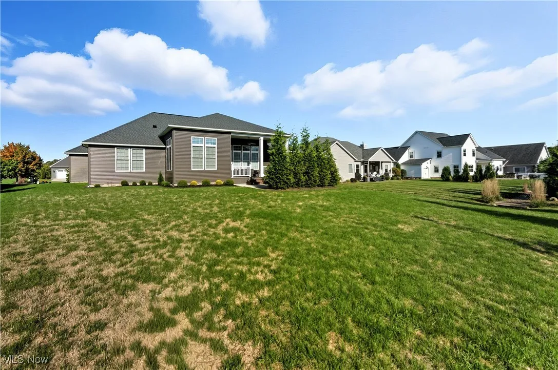 Back of house with a lawn