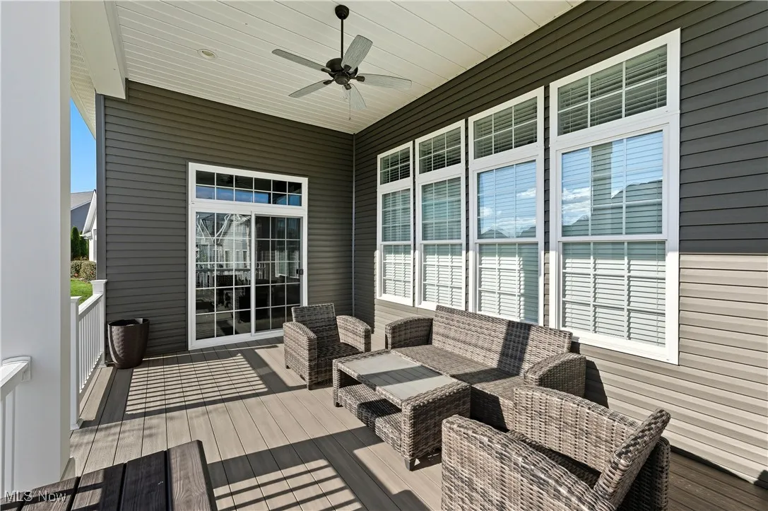 Deck with a ceiling fan and an outdoor living space