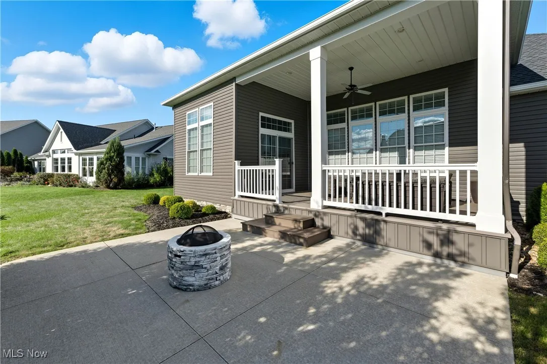 View of patio featuring an outdoor fire pit and a ceiling fan