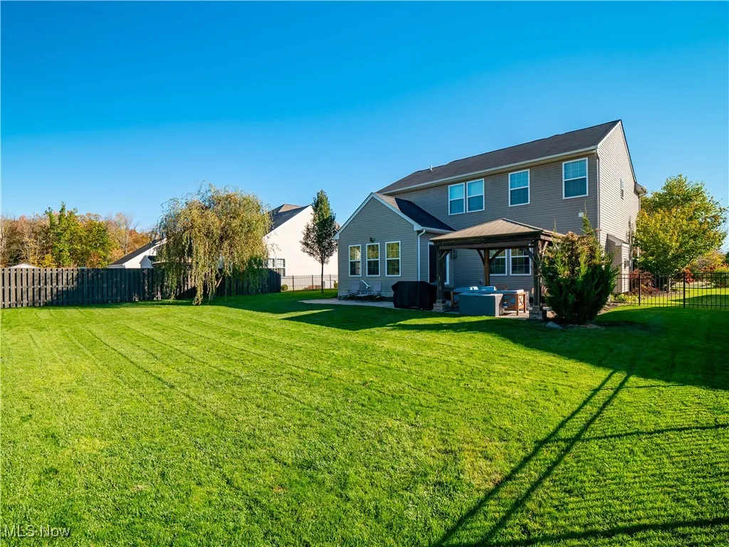 Back of house featuring a fenced backyard, a patio area, and a gazebo