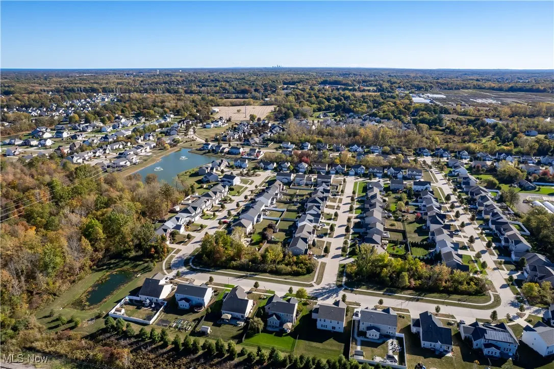 Aerial overview of property's location with nearby suburban area and a nearby body of water