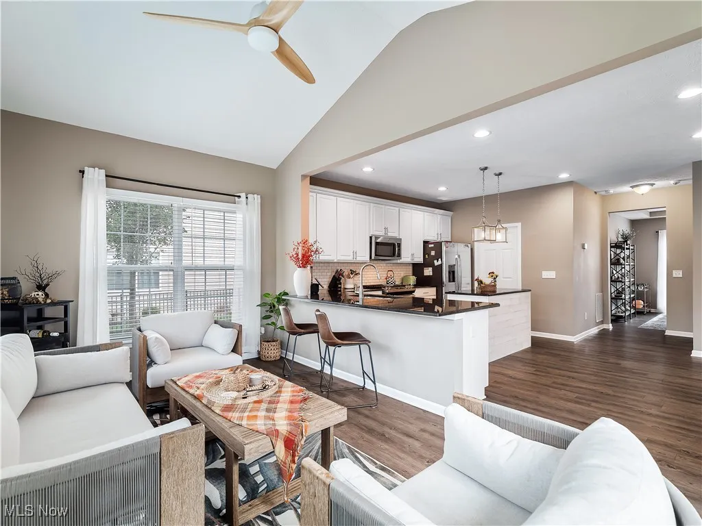 Living area featuring recessed lighting, dark wood finished floors, a ceiling fan, and vaulted ceiling