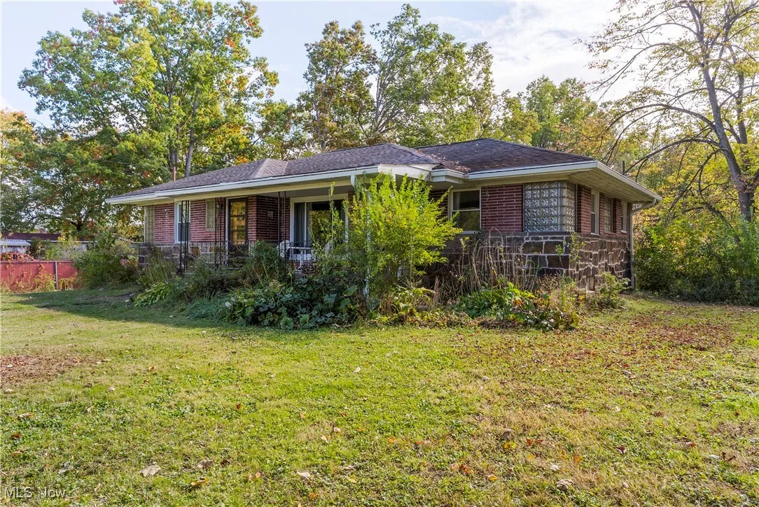Ranch-style house featuring brick siding