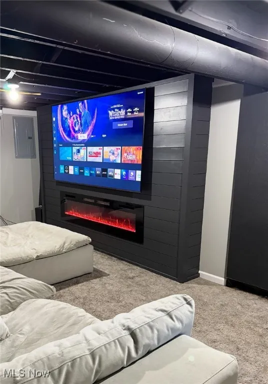 Inviting home theater with a glass-enclosed fireplace, creating the perfect atmosphere for movie watching