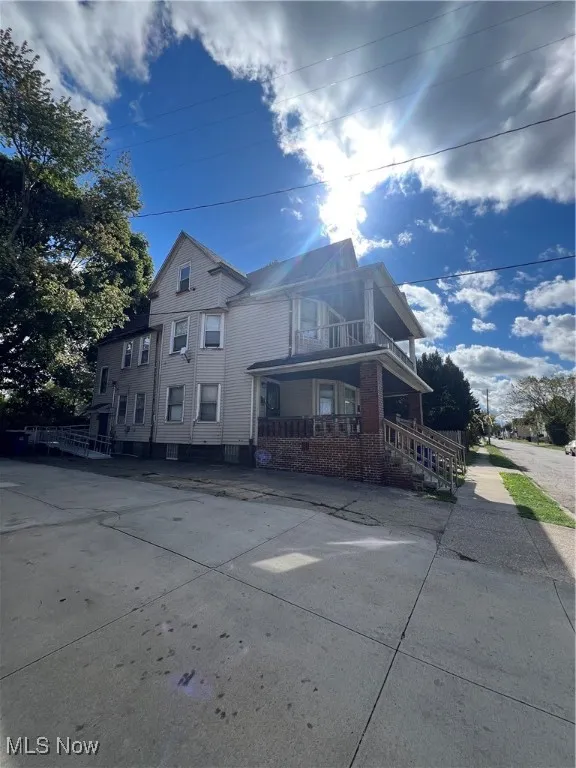 View of property exterior featuring a balcony