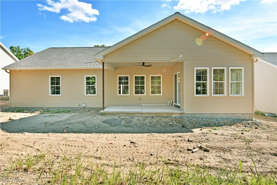 Back of property featuring a patio area, ceiling fan, and a shingled roof