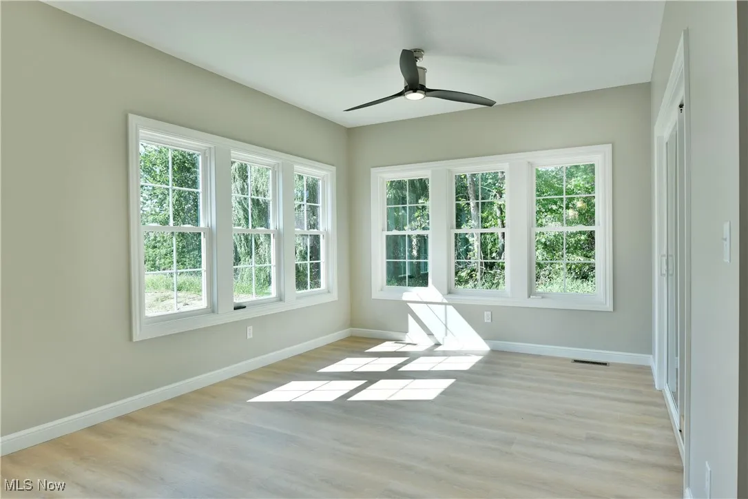 Spare room with light wood-style flooring and a ceiling fan