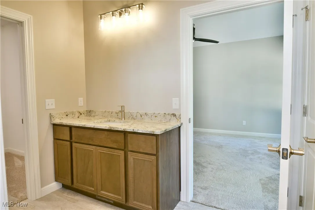 Bathroom featuring vanity and ceiling fan