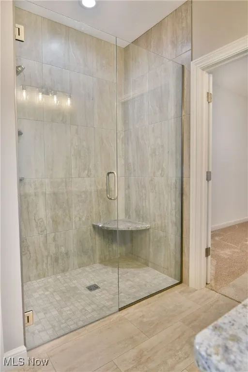 Bathroom featuring a shower stall and recessed lighting