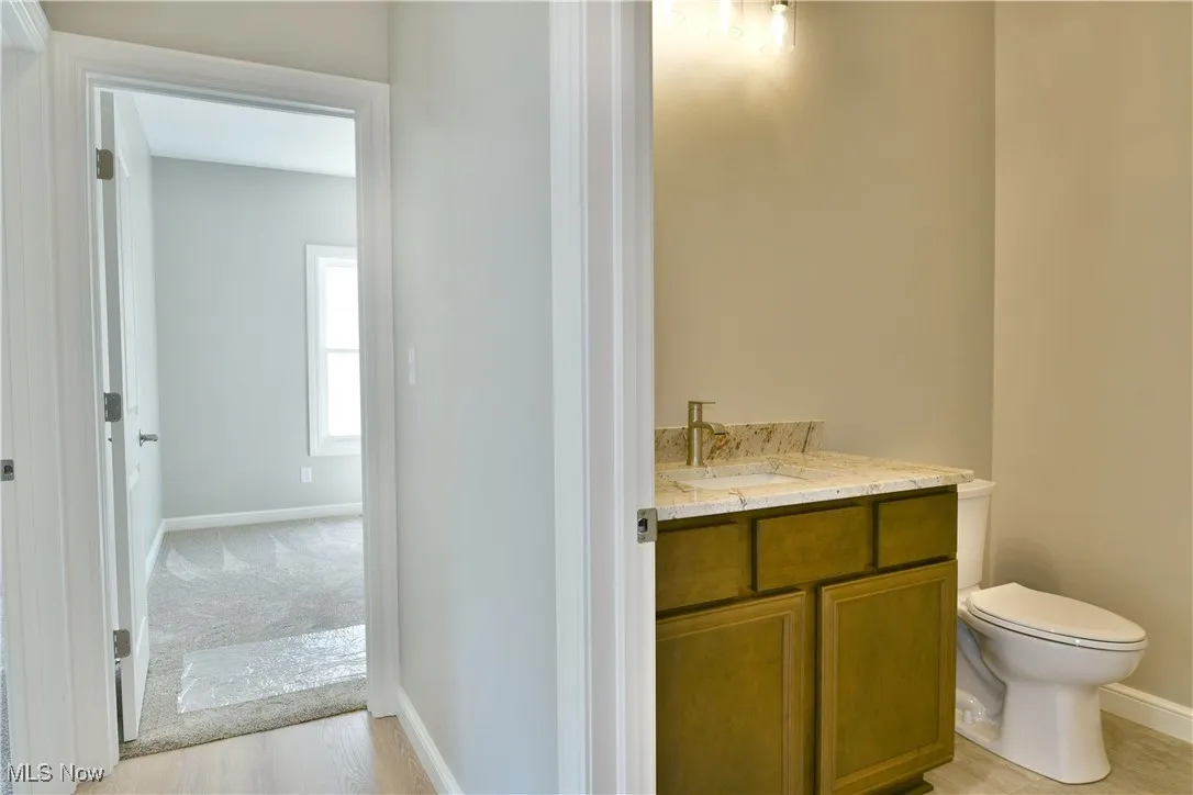 Half bathroom with vanity and light wood-style floors