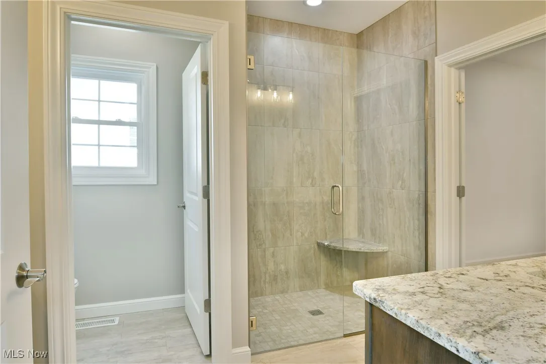 Bathroom with a stall shower and vanity