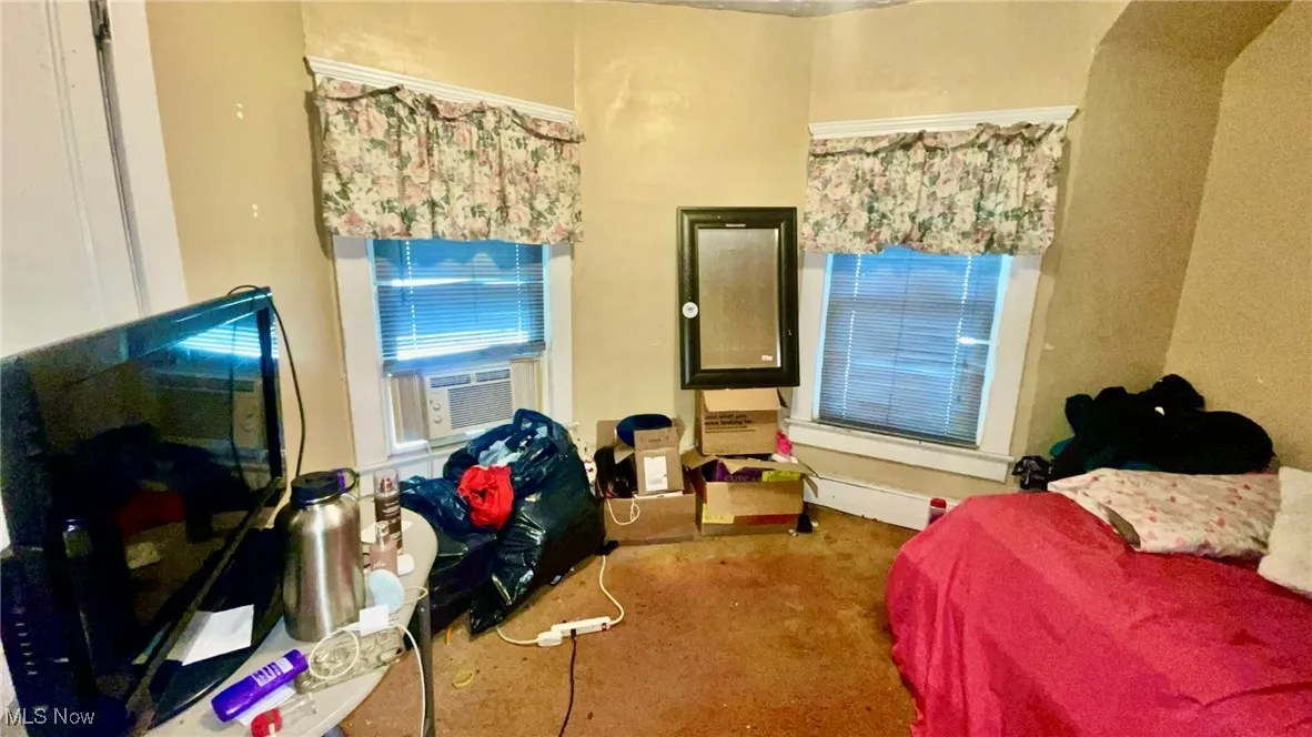 Bedroom featuring carpet and cooling unit