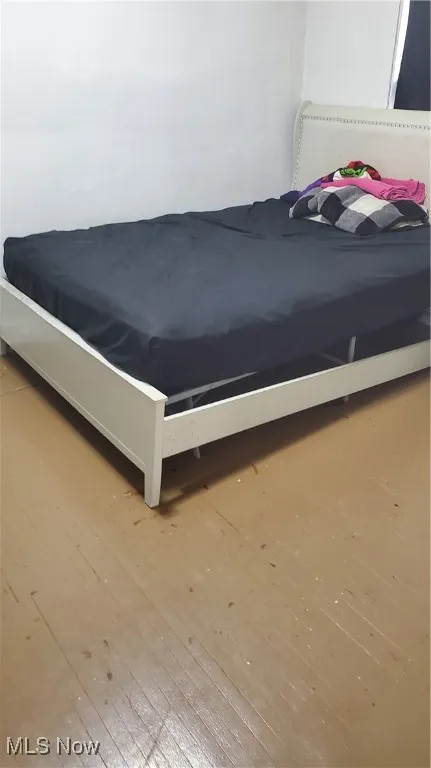Bedroom featuring wood-type flooring