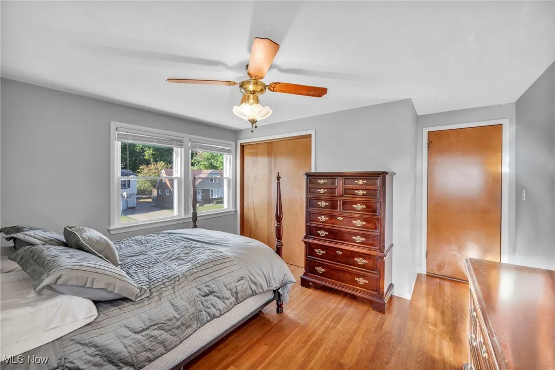 Bedroom featuring light wood finished floors, a closet, and ceiling fan