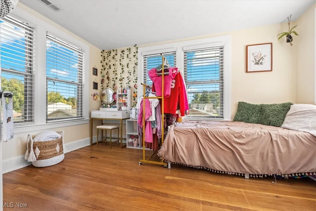 Bedroom featuring wood finished floors and baseboards
