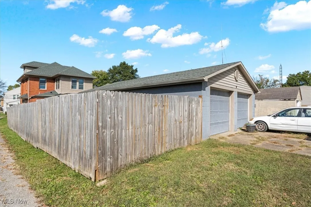 View of side of home featuring a fenced backyard and concrete block siding