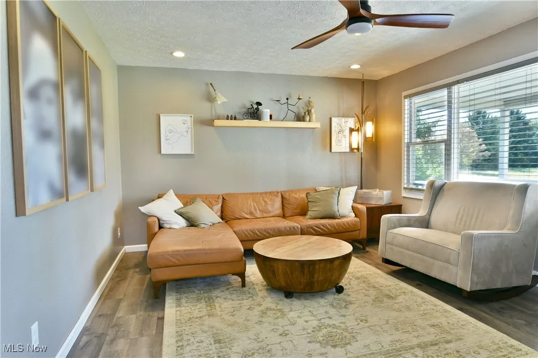 Sitting room featuring wood finished floors, a textured ceiling, recessed lighting, and a ceiling fan