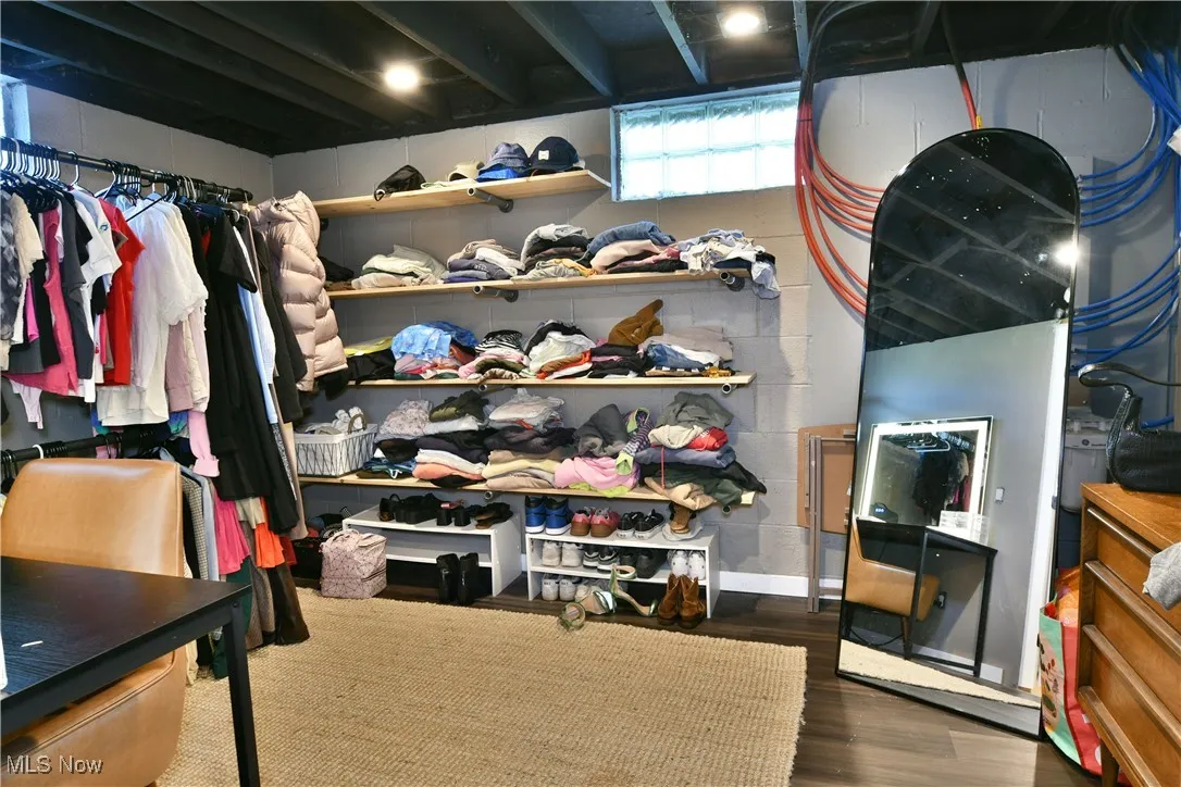 Walk in closet featuring dark wood-style flooring