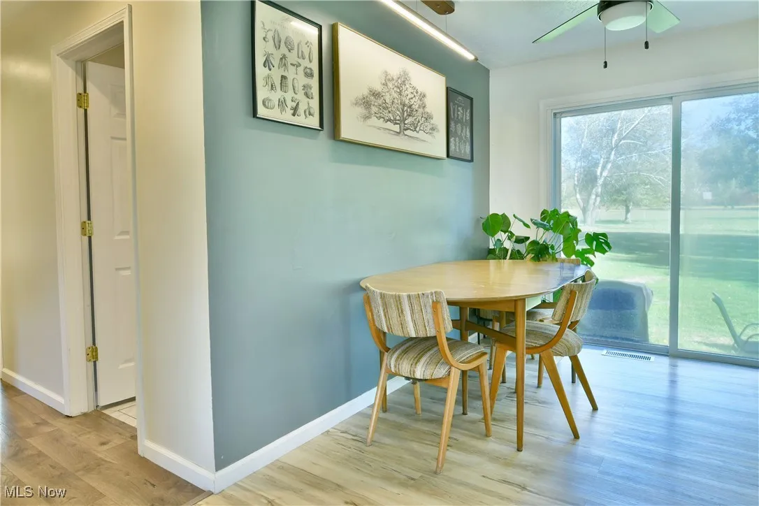 Dining room featuring light wood-style flooring and a ceiling fan