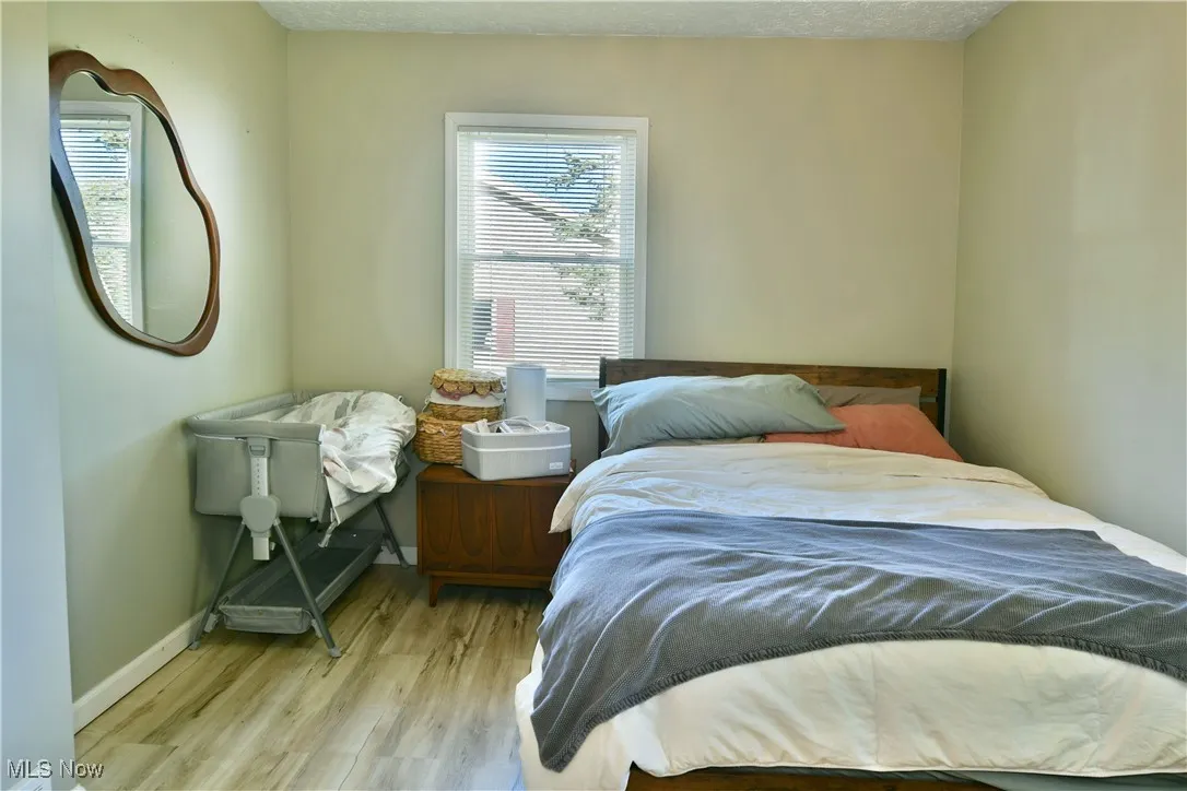 Bedroom featuring light wood-style flooring and a textured ceiling