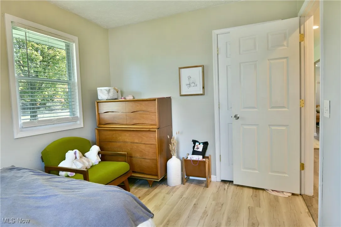 Bedroom with light wood-style flooring and a textured ceiling
