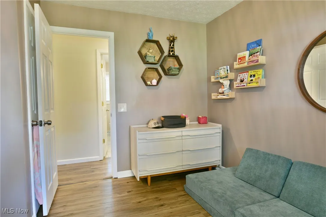 Living area featuring wood finished floors and a textured ceiling