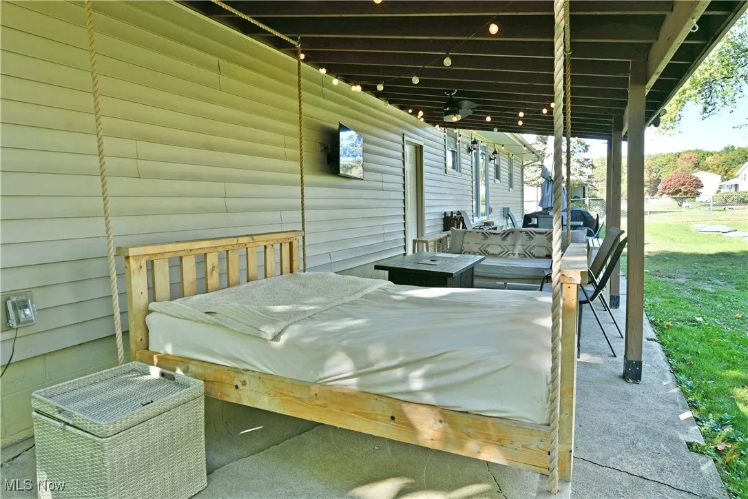 View of patio with a ceiling fan and a deck