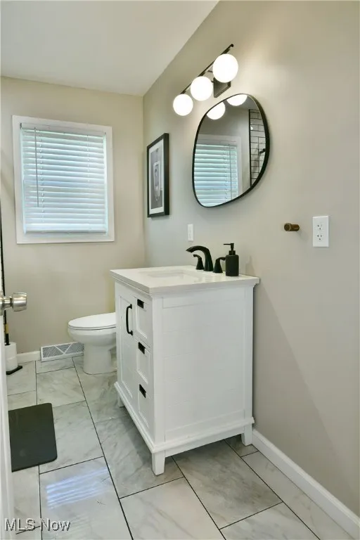 Bathroom featuring baseboards and vanity