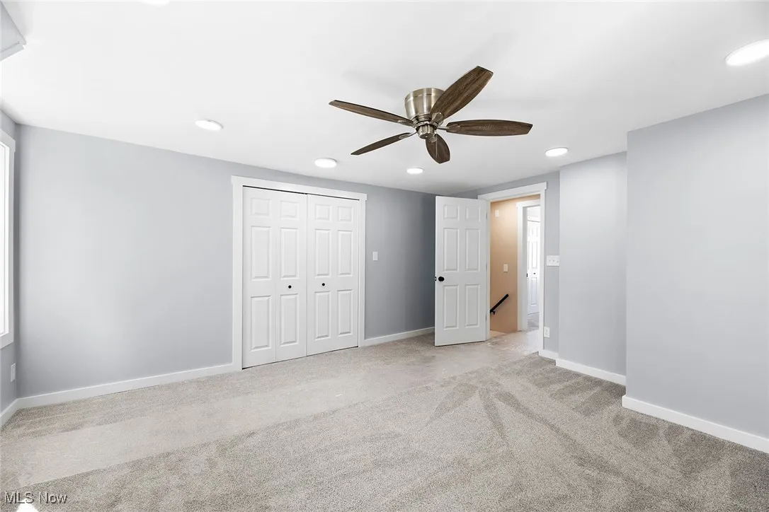 Unfurnished bedroom featuring carpet floors, recessed lighting, a closet, and a ceiling fan