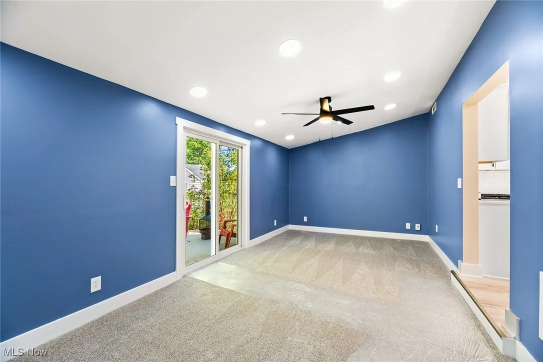 Empty room featuring light colored carpet, recessed lighting, and ceiling fan